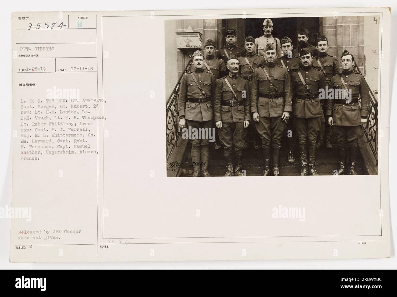 The photograph shows a group of military personnel in Ungersheim, Alsace, France during World War One. The individuals in the photo are identified as Lt. Arrivete, Capt. Serges, Lt. Kubert in the top row, Lt. H.M. Landon, Lt. D.H. Vaugh, Lt. F.B. Thompson, Lt. Robert Whittlesy in the 24th row, and Capt. E.J. Parrell, Maj. E.L. Whittermore, Co. Win. Hayward, Capt. Robt. F. Ferguson, Capt. Samuel Shethar in the front row. The specific date of the photo is not provided. Stock Photo