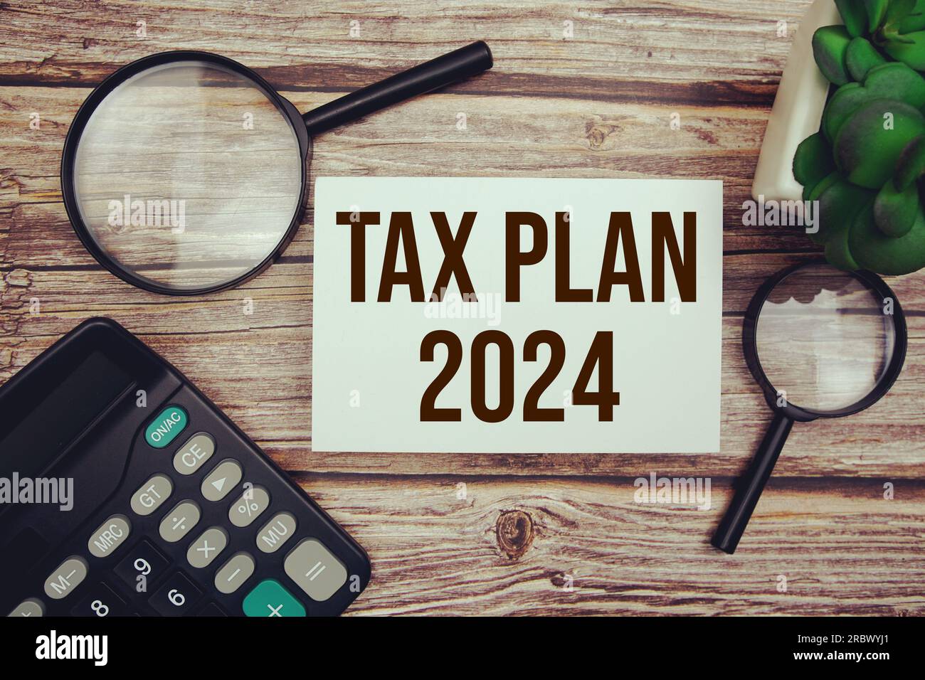 Tax plan 2024 with magnifying glass on wooden background Stock Photo ...