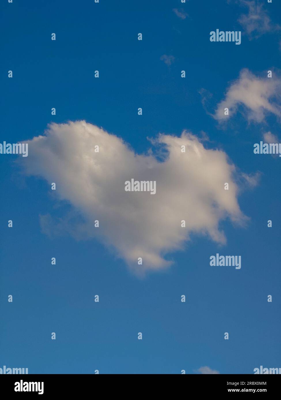White puffy heart shaped cloud set against a deep blue summer sky Stock ...