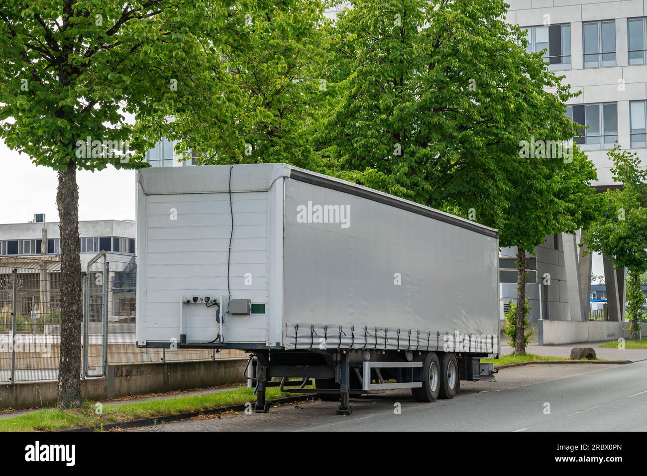 Large semi-trailer parked on the side of the city road Stock Photo - Alamy