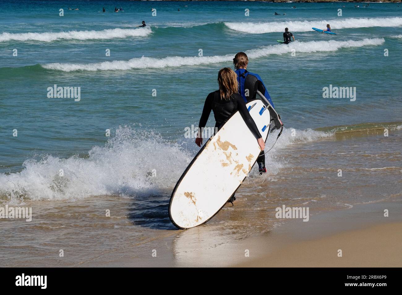2 surfers on the beach of Sydney, Australia Stock Photo