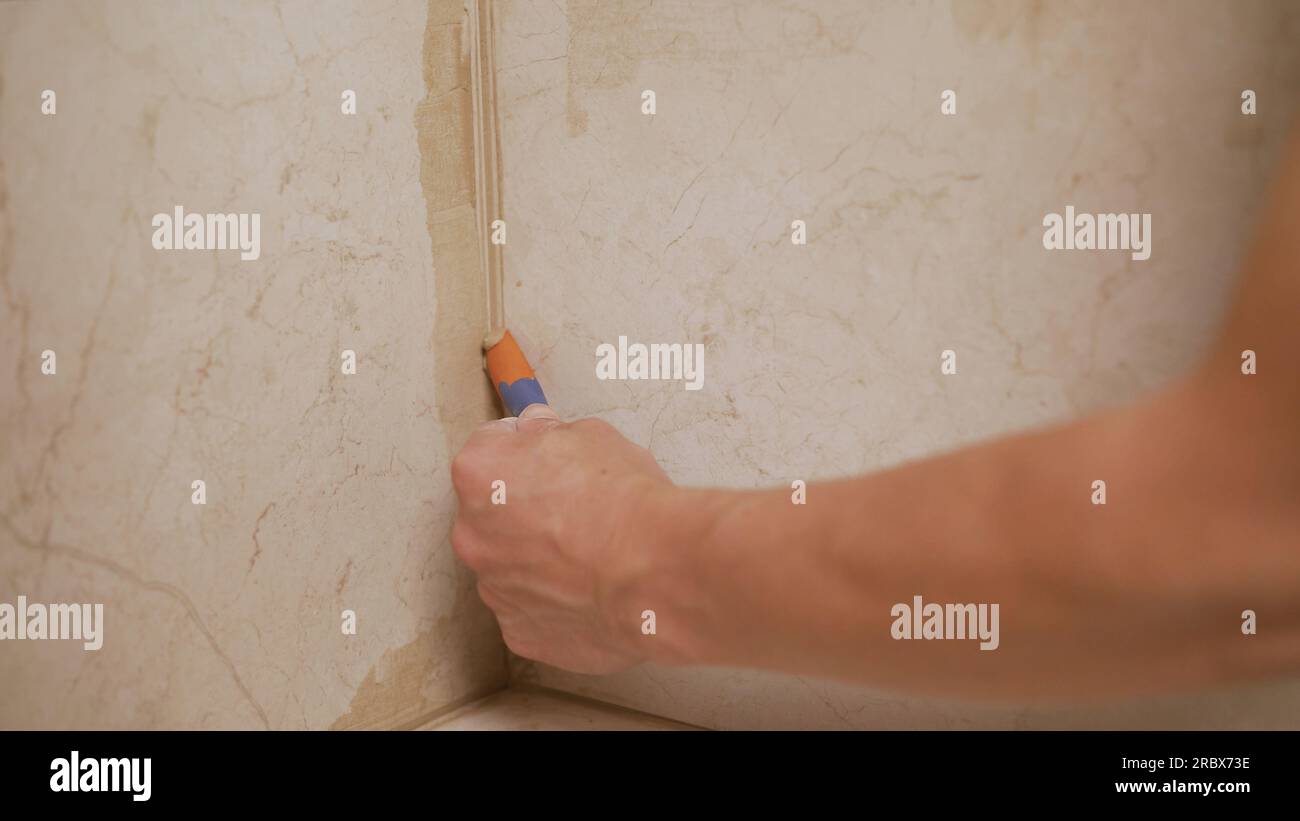 Close-up of a professional cleaner cleaning solution on bathroom tiles ...