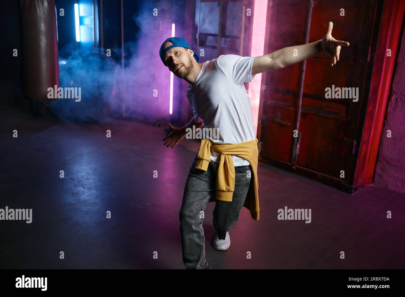 Cool and happy Hip hop dancer in trendy street clothes dancing Stock Photo