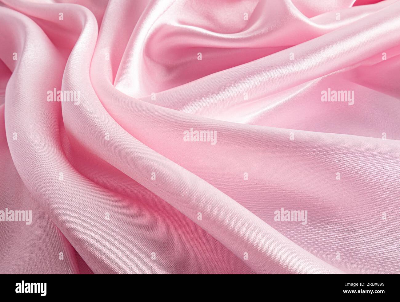 Abstract texture background of pink satin fabric. soft folds of silk ...