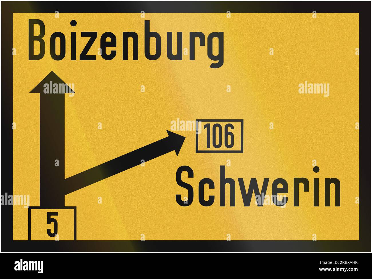 Old design (1956) of a German direction sign on a federal road showing the way to Boizenburg and Schwerin. Stock Photo