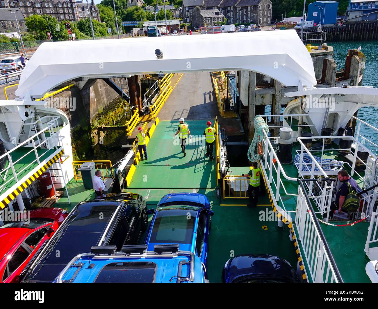 Workers prepare ramp for vehicles exiting CalMac ferry on route from