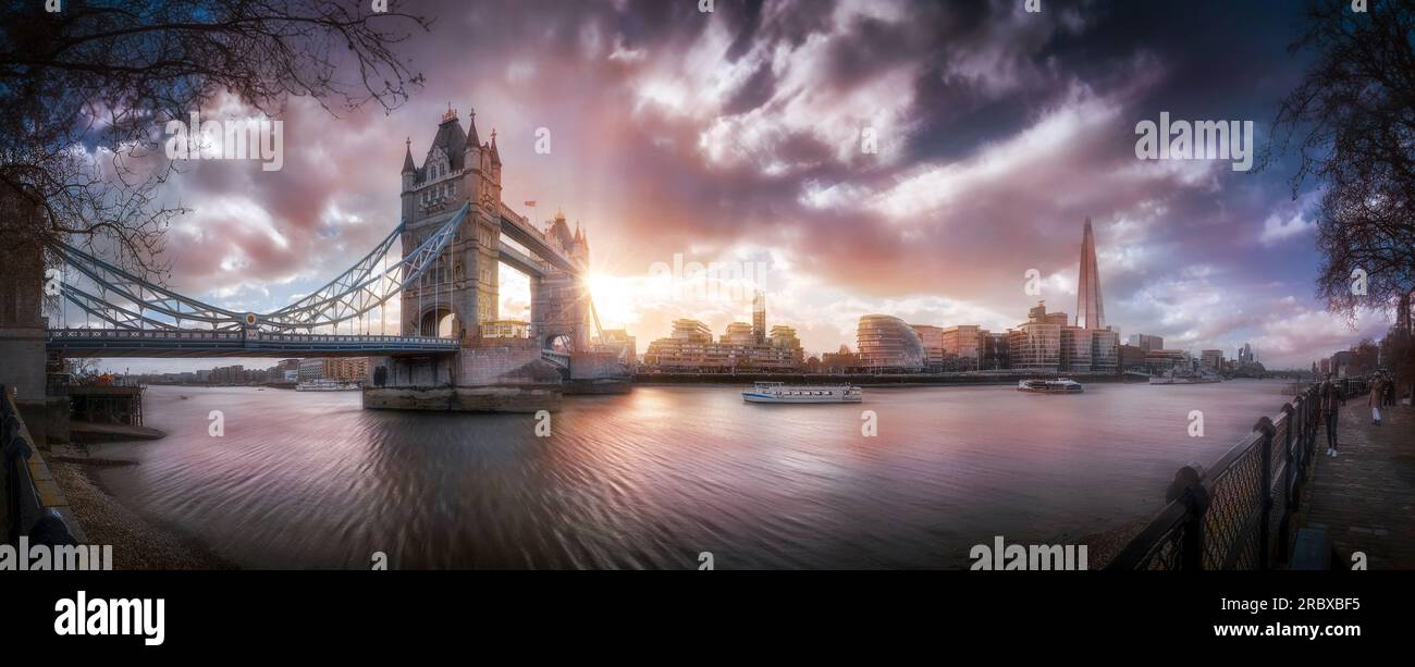 walking along the banks of the Thames enjoying the view of the Tower Bridge in a magical moment while sun in shining Stock Photo