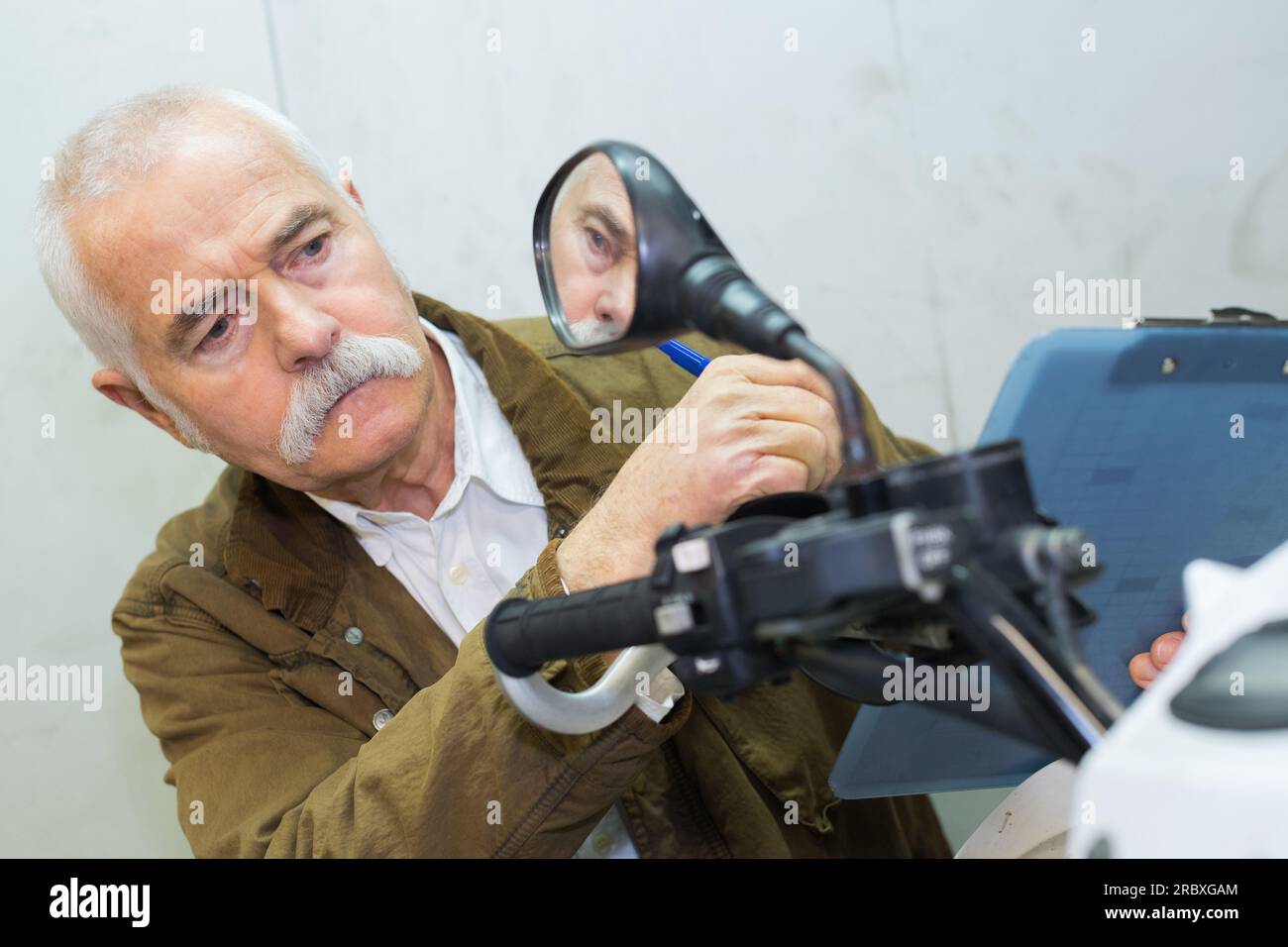 mechanic adjusting mirror on handlebars Stock Photo Alamy