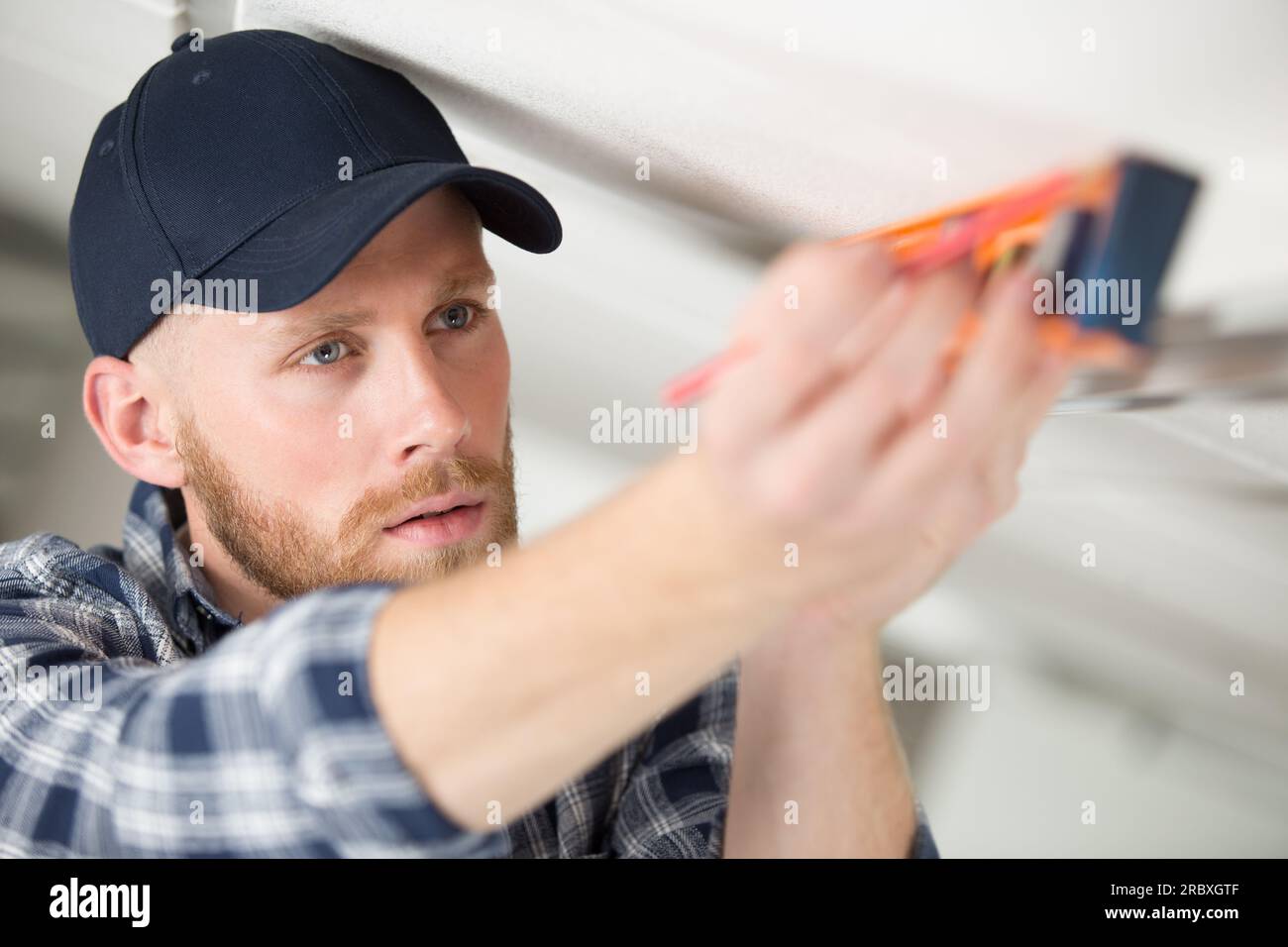 workman using a spirit level Stock Photo