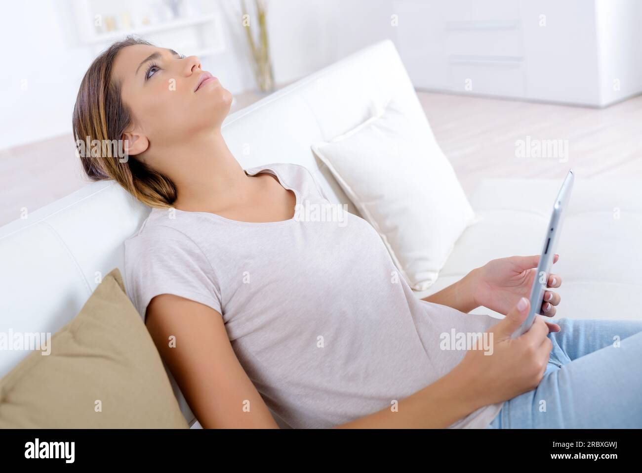 woman on the sofa with tablet Stock Photo