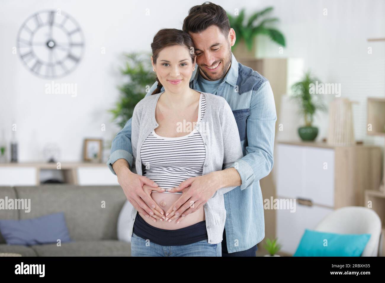 happy man hugging his pregnant wife standing at home Stock Photo - Alamy