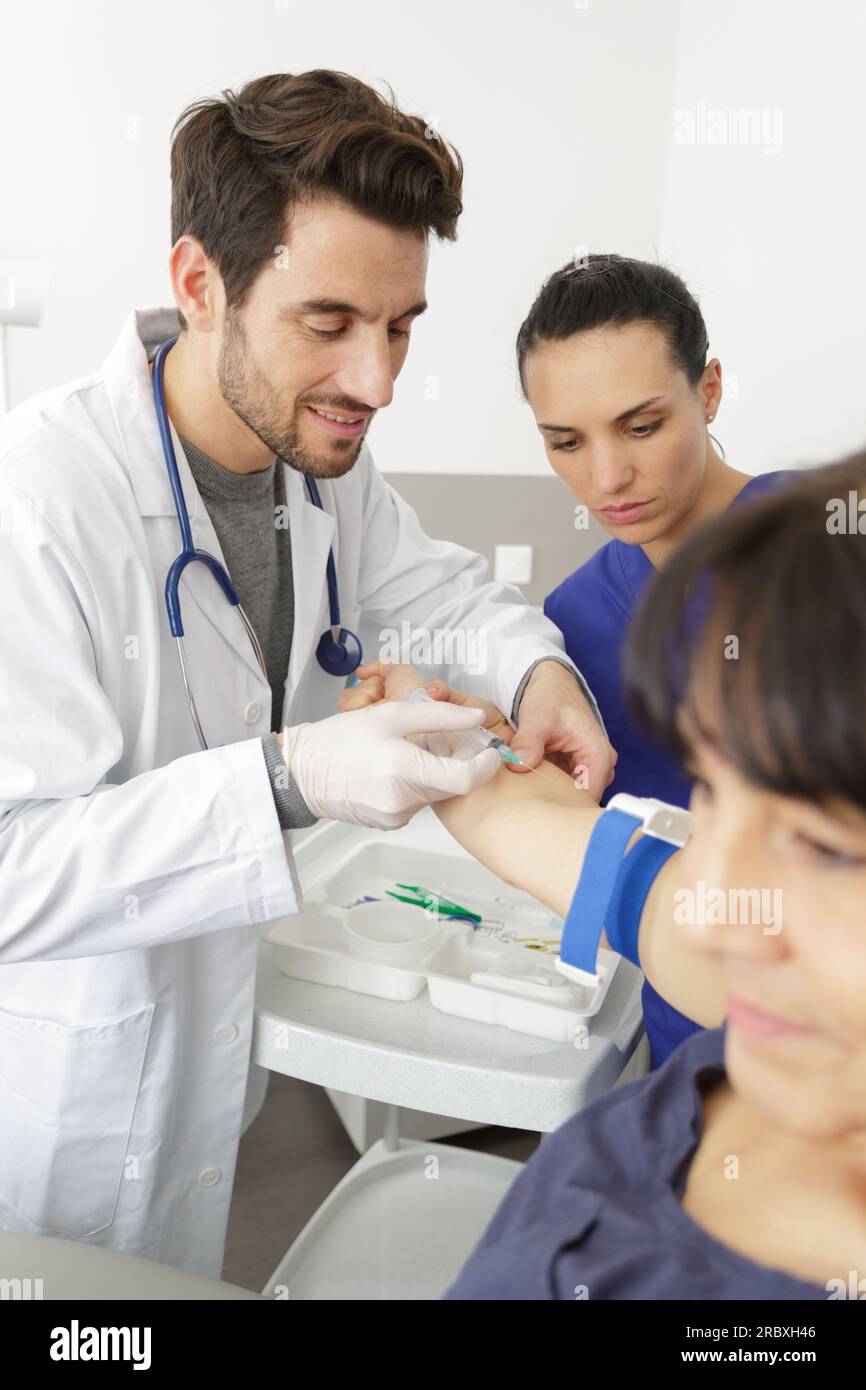 doctor doing a blood test on mature female patient Stock Photo Alamy