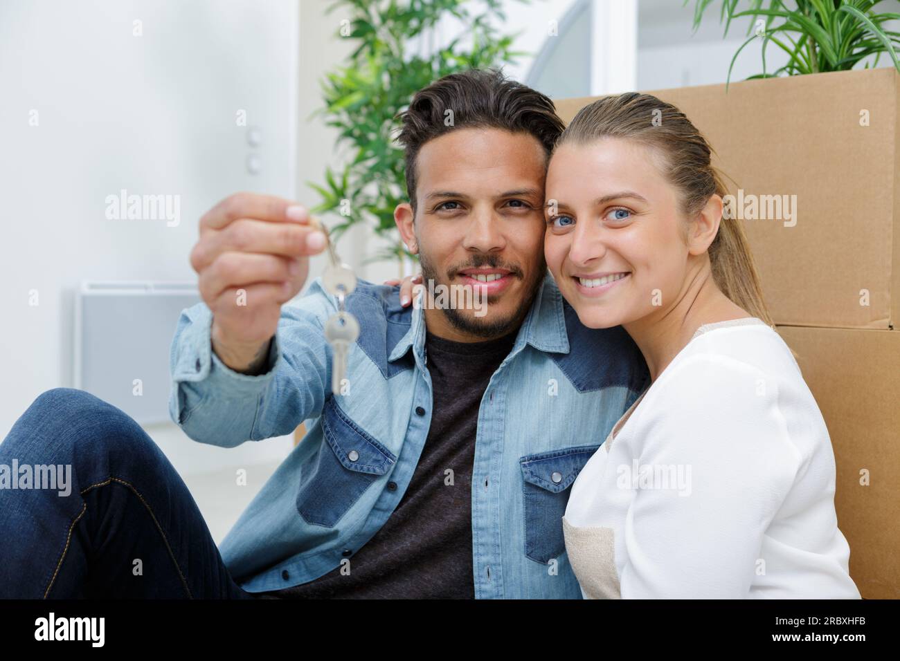 couple with key in a new apartment for a housewarming Stock Photo - Alamy