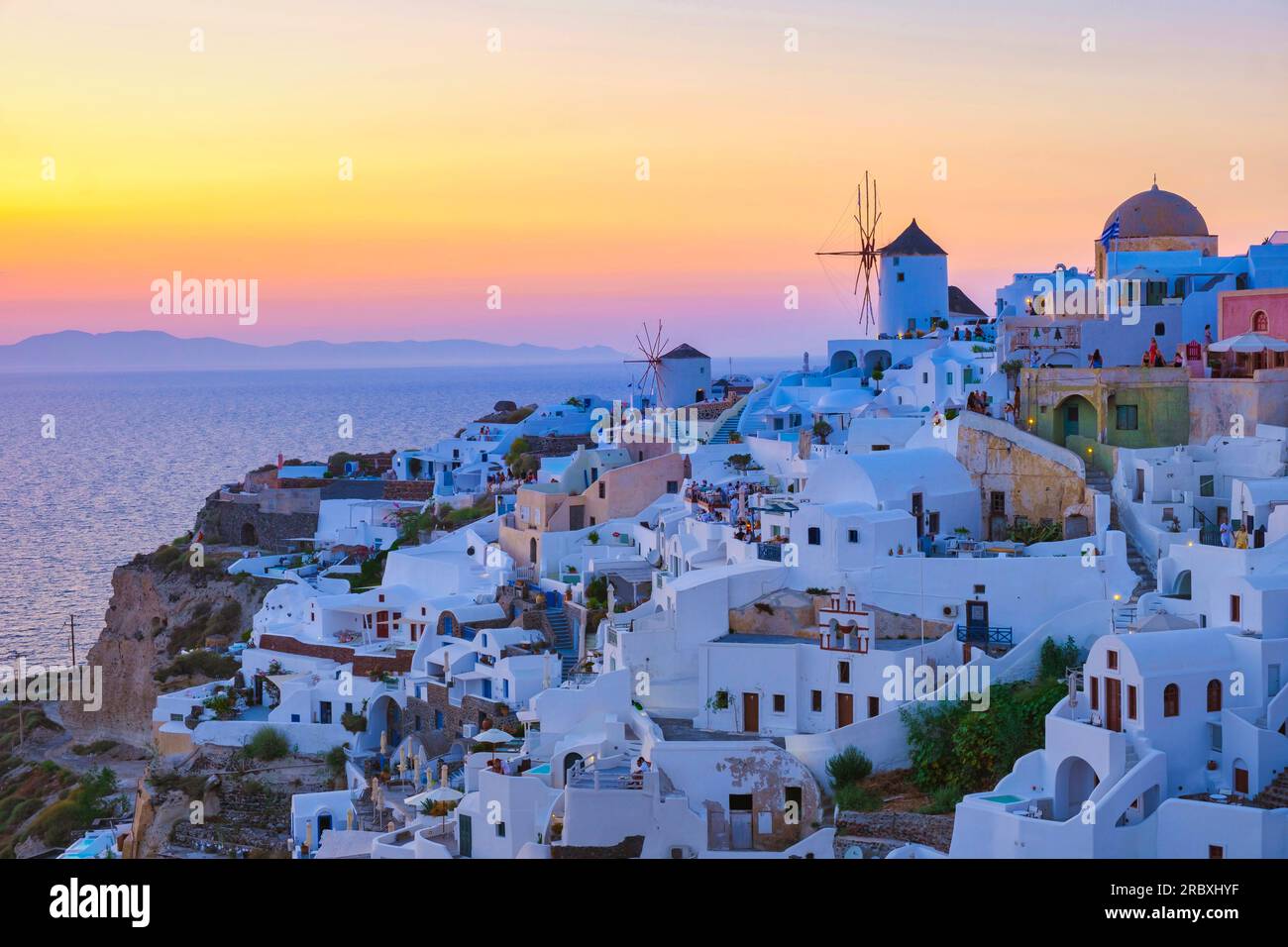 Sunset With White Churches An Blue Domes By The Ocean Of Oia Santorini sunset-with-white-churches-an-blue-domes-by-the-ocean-of-oia-santorini