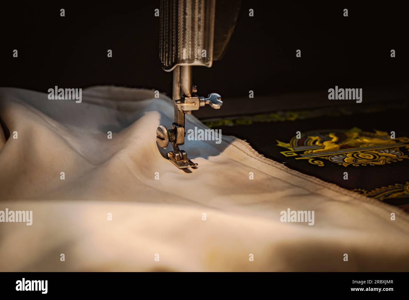 Close up of sewing machine with old white fabric. Stock Photo