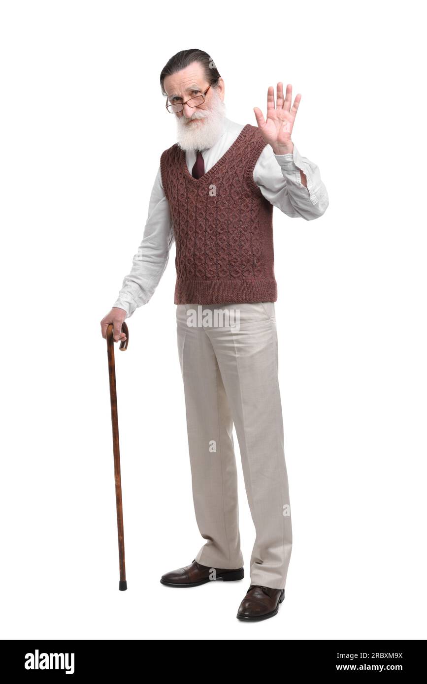 Senior man with walking cane waving on white background Stock Photo - Alamy