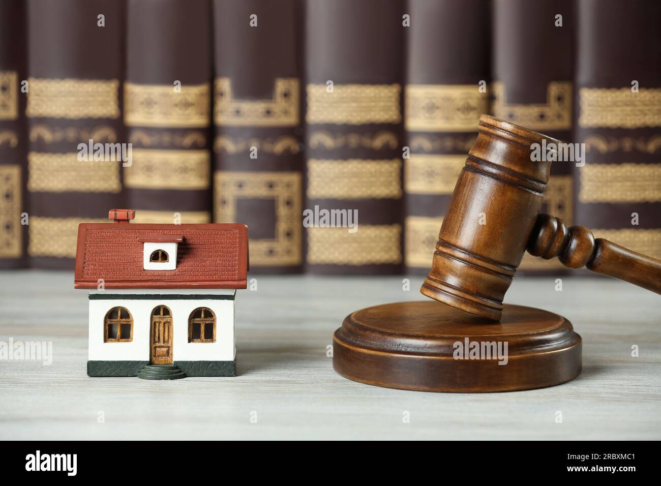 Construction and land law concepts. Judge gavel, house model with books on wooden table Stock Photo