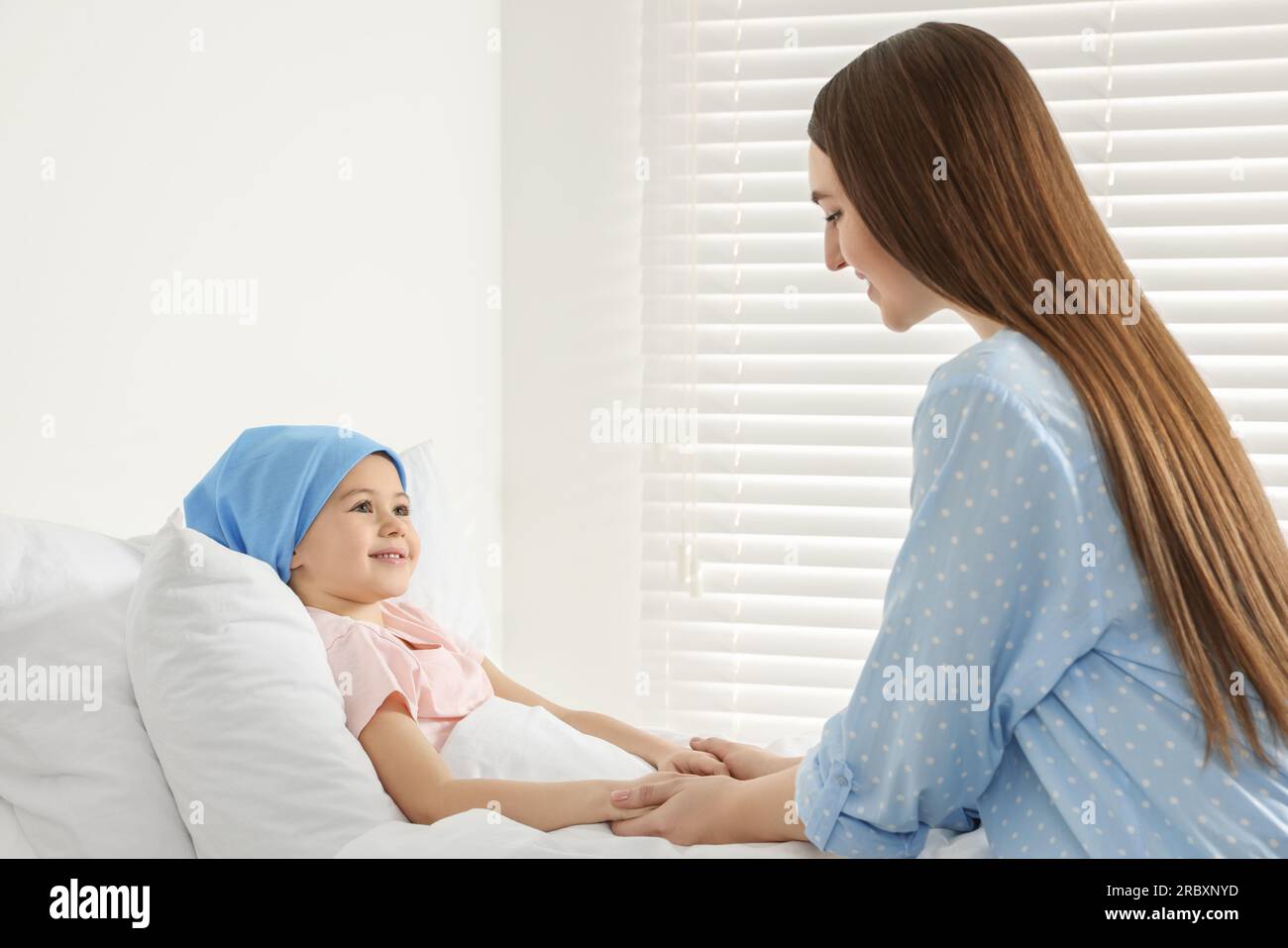Childhood cancer. Mother and daughter in hospital Stock Photo