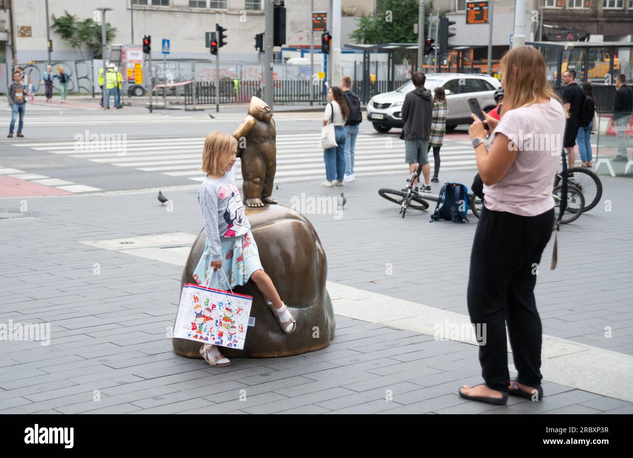 Young girl posing with the major Gnome, in Wroclaw, Poland Stock Photo