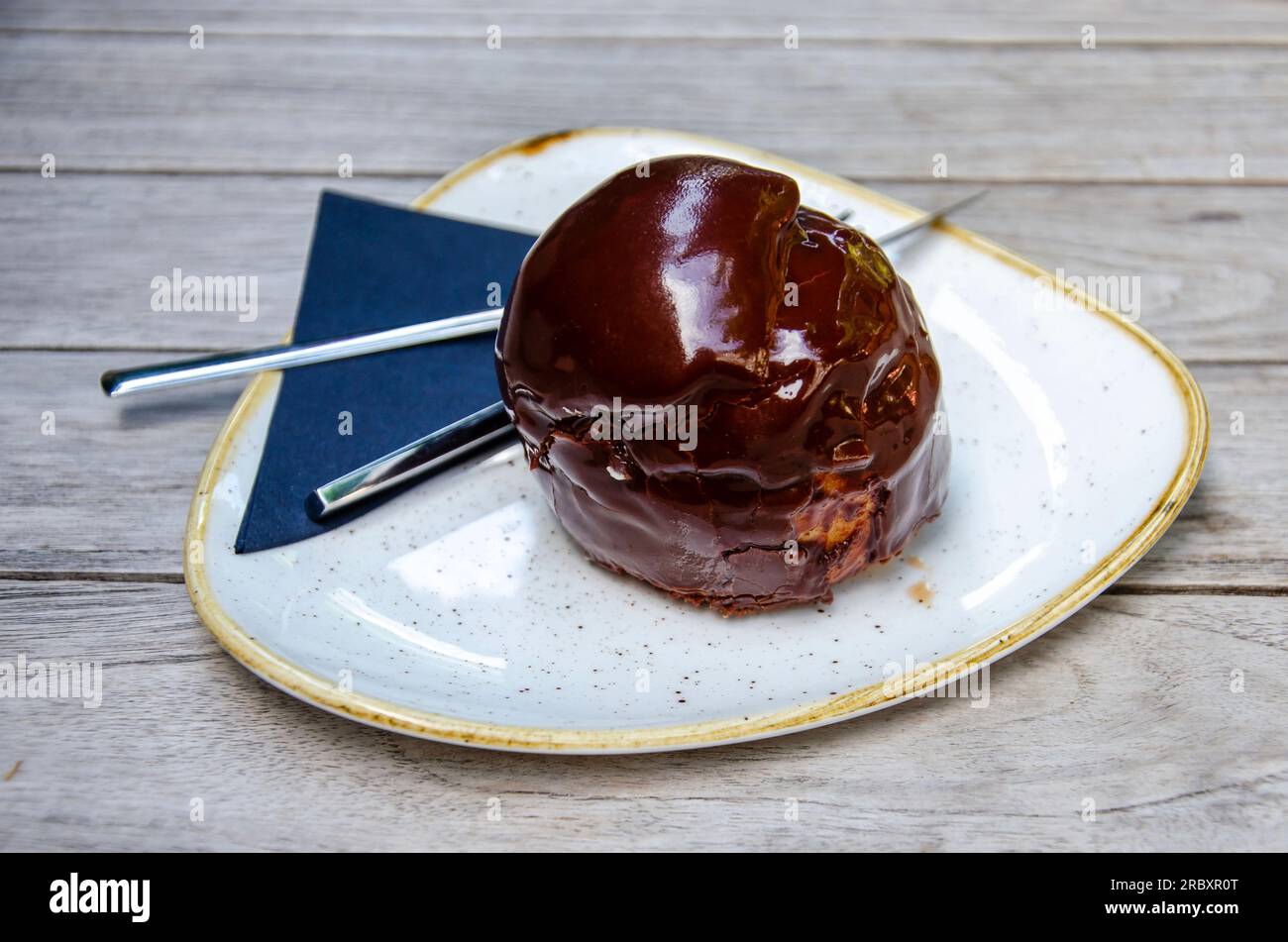 A Bossche Bol, signature snack of the city of Den Bosch, The Netherlands, with whipped cream