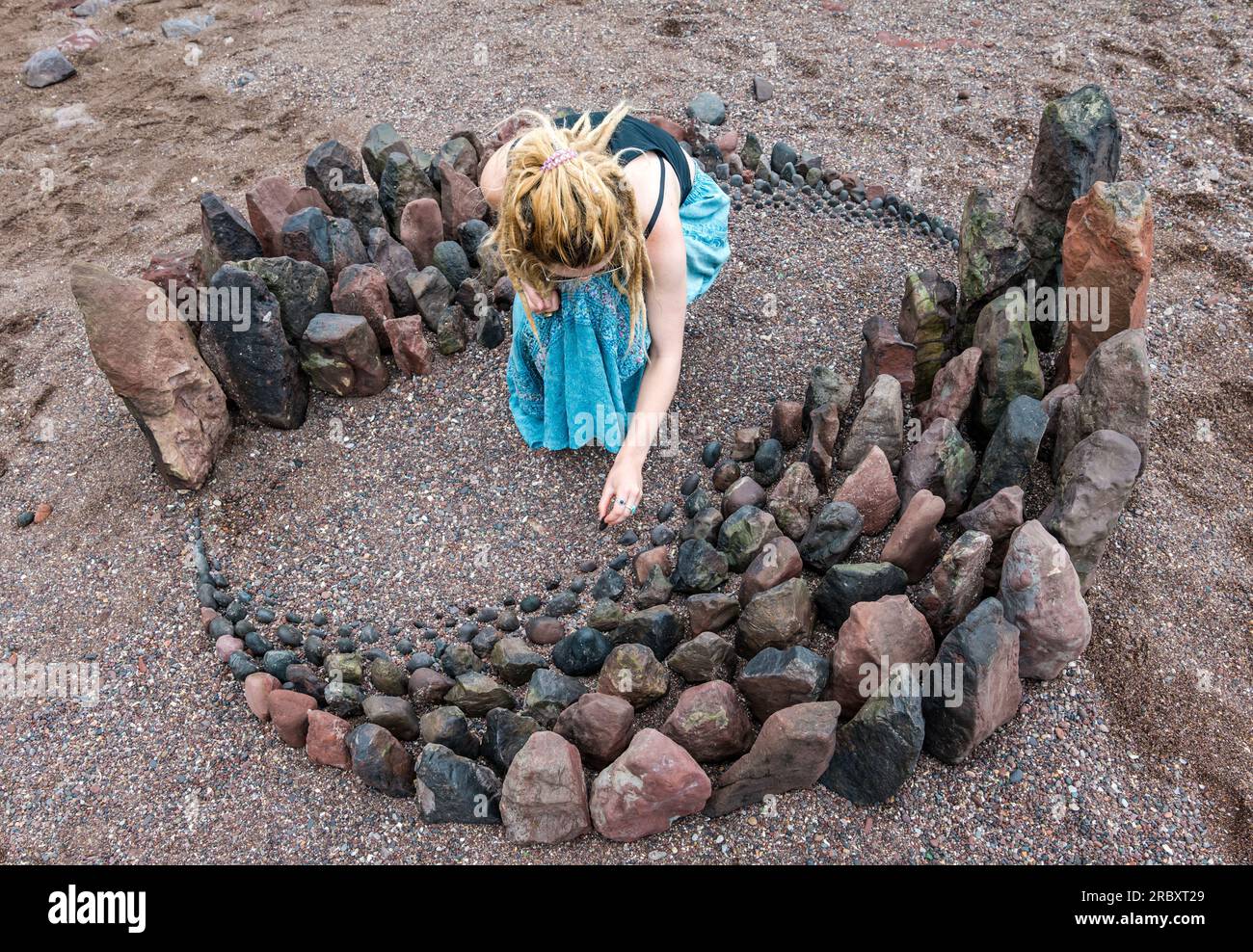 A land artist creates a stone sculpture, European Land Art Festival