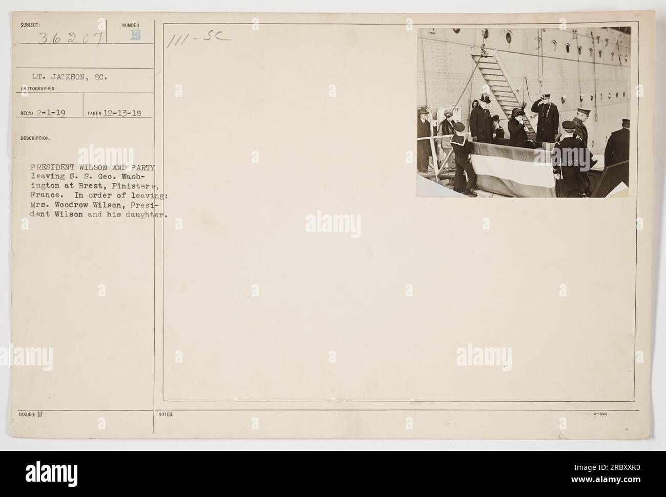 President Woodrow Wilson and his party are seen leaving the S.S. Geo. Washington at Brest, Finistere, France. The photograph was taken on December 13, 1918, by Lieutenant Jackson. The individuals pictured include Mrs. Woodrow Wilson, President Wilson, and his daughter. Stock Photo