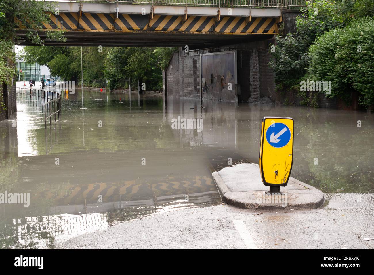 Flood water on road during storm. Keep left sign. Stockport, Greater Manchester UK Stock Photo