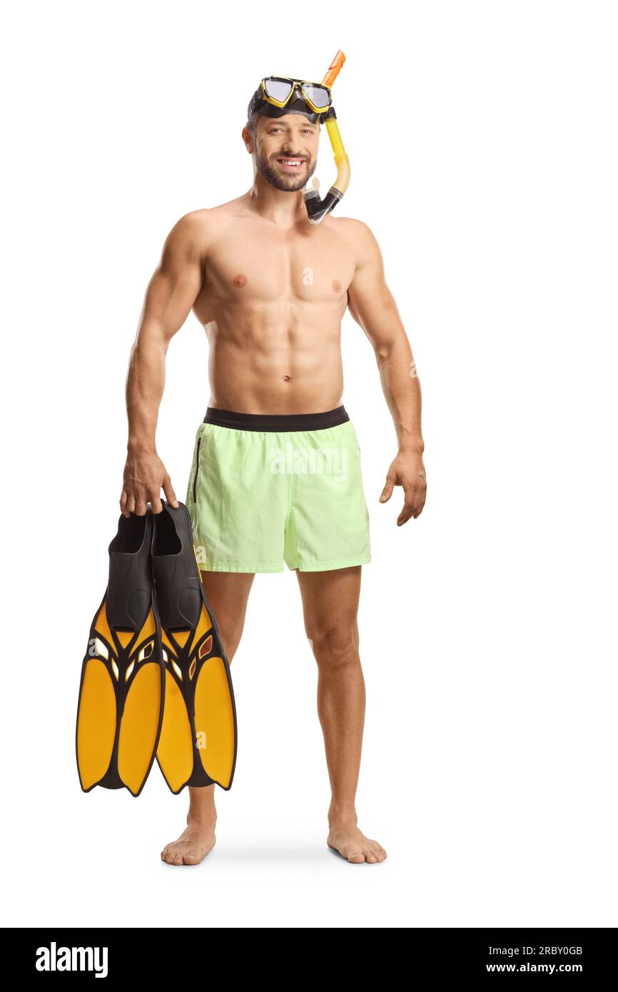 Full length portrait of a young man in a swimsuit with a diving mask holding snorkeling fins isolated on white background Stock Photo