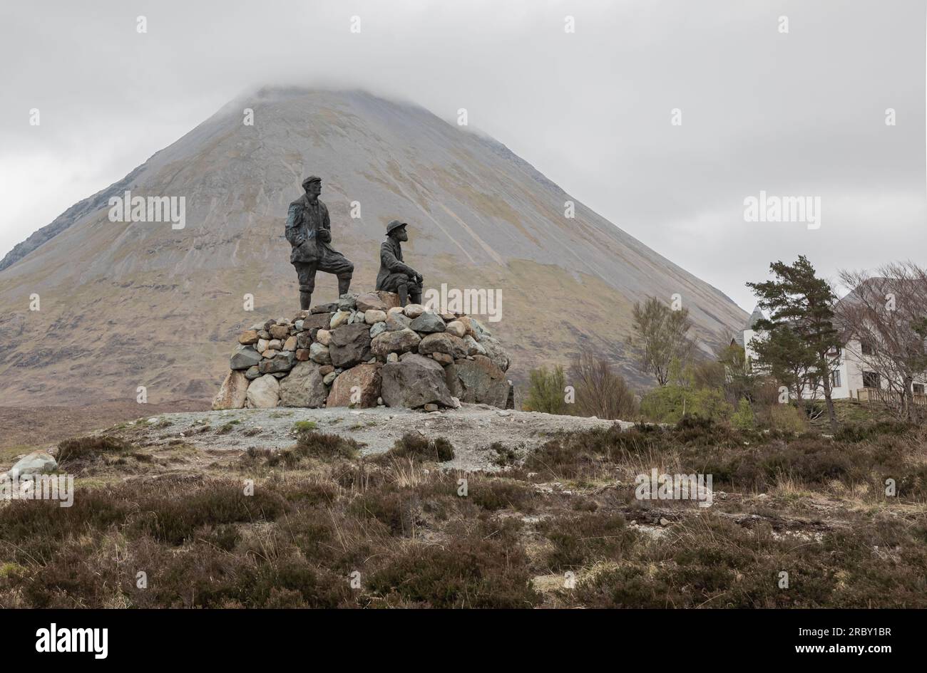 Two statues on a pile of stones in the Scottish highlands on a misty cold day Stock Photo