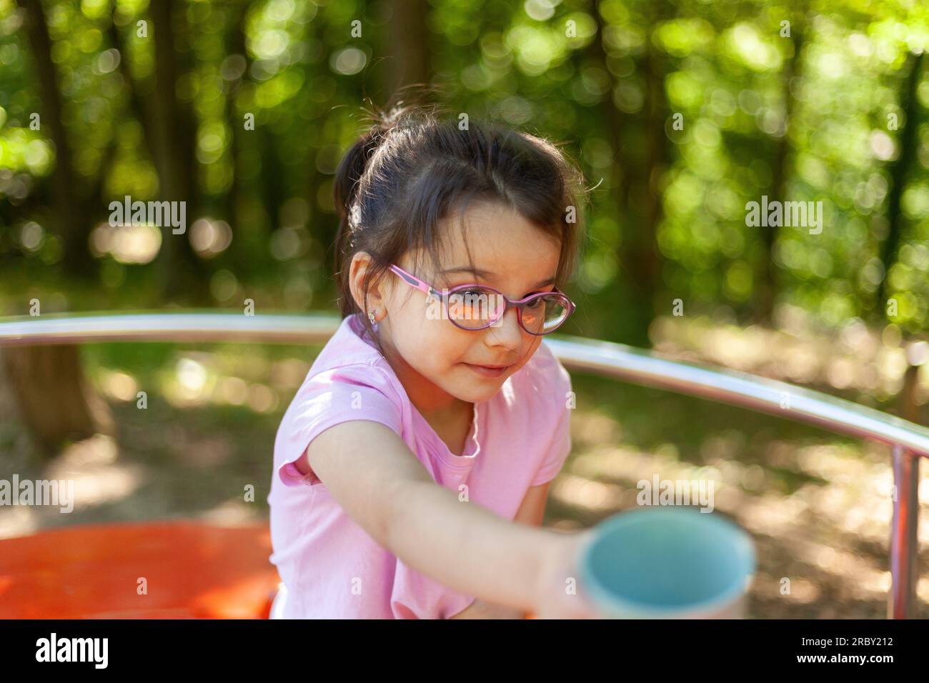 Cute little girl playing on the playground in the park. Outdoor Stock ...