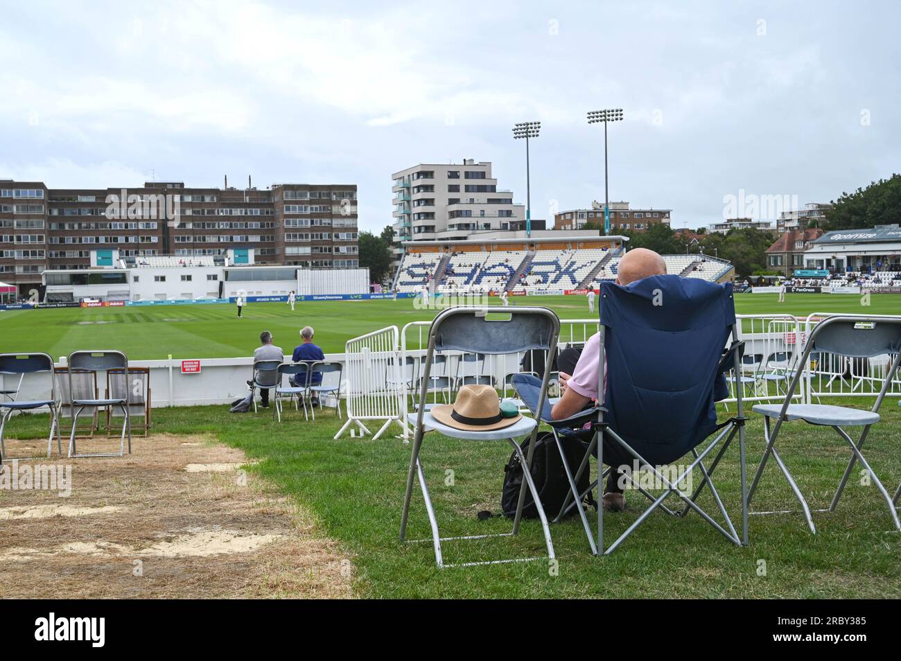 Hove UK 11th July 2023 -  Spectators watch Sussex take on Derbyshire in gloomy conditionsduring day two of the LV= Insurance County Championship cricket match at the 1st Central County Ground in Hove : Credit Simon Dack /TPI/ Alamy Live News Stock Photo