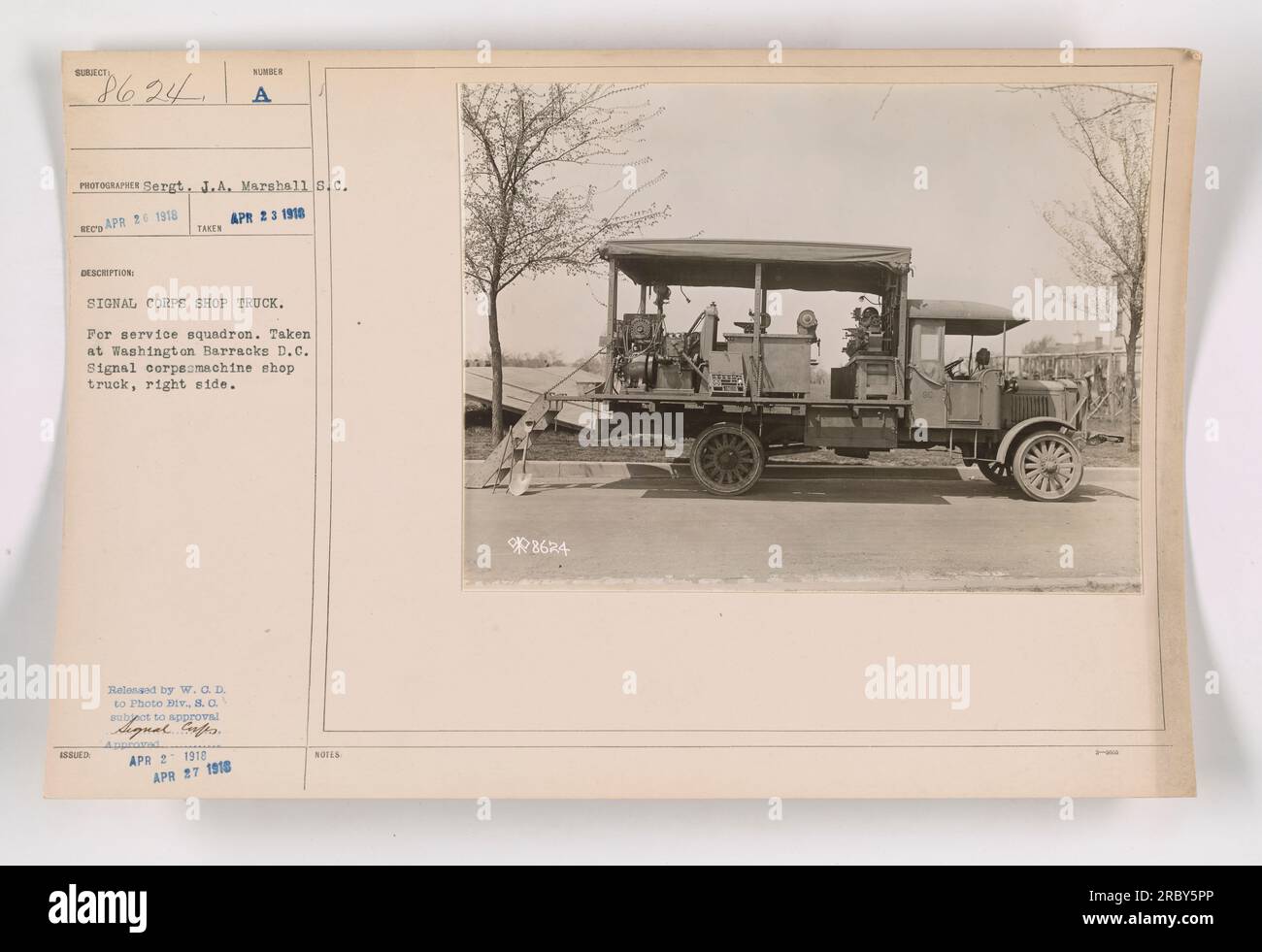One of the photographs in the series, labeled 111-SC-8624, shows a Signal Corps shop truck being operated by a service squadron at Washington Barracks, D.C. The photo was taken on April 23, 1918, by Sergeant J.A. Marshall. It depicts the right side of the machine shop truck, which is marked with the Signal Corps logo. The details mentioned in the notes include a reference number, timestamps, and approval signatures. Stock Photo