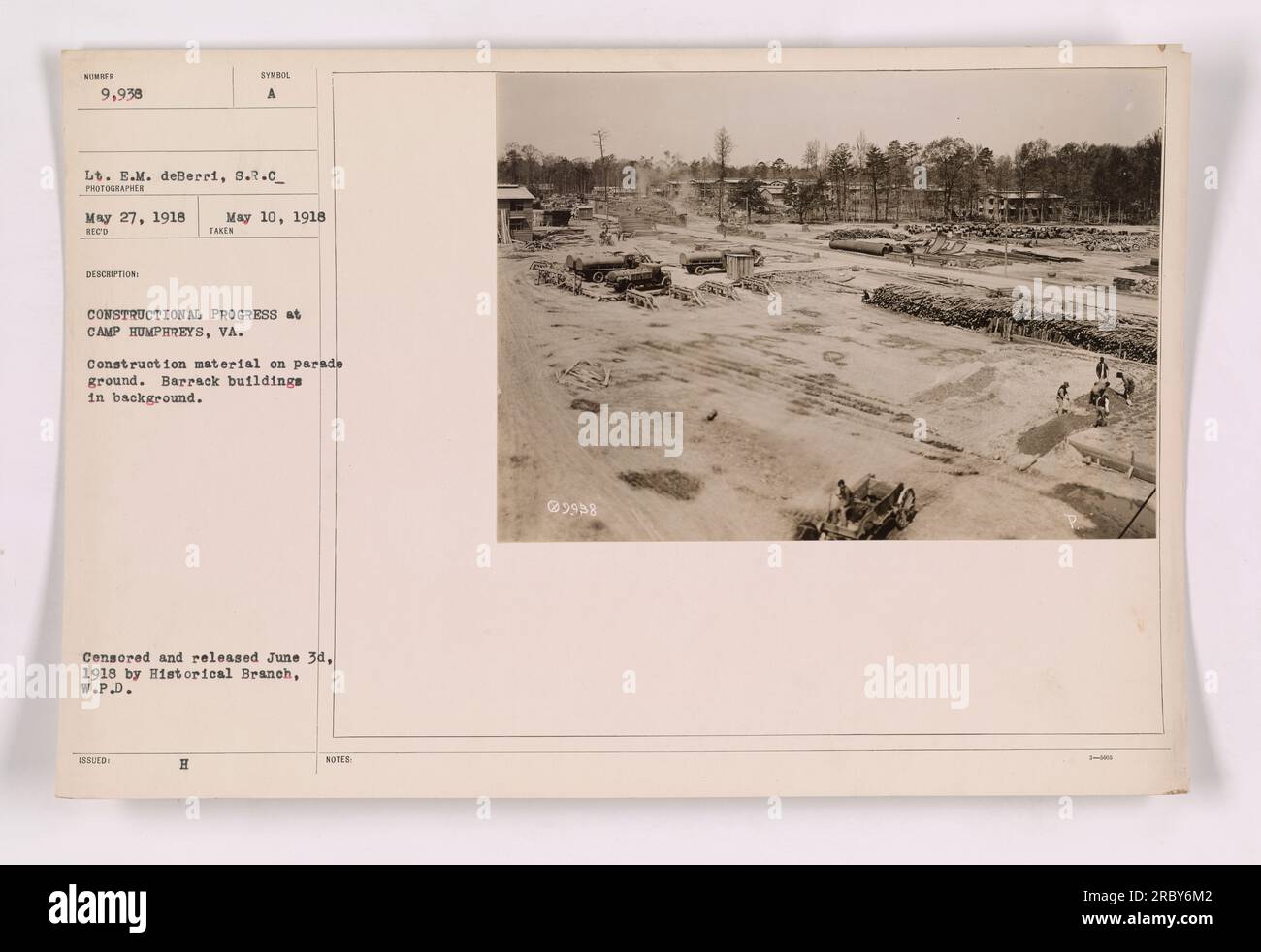 Construction materials are seen on the parade ground of Camp Humphreys, Virginia, in this photograph taken on May 27, 1918. The image shows barracks buildings in the background, highlighting the construction progress taking place at the camp during World War I. The photo was taken by Lt. E.M. deBerri and was censored and released on June 3, 1918. Stock Photo