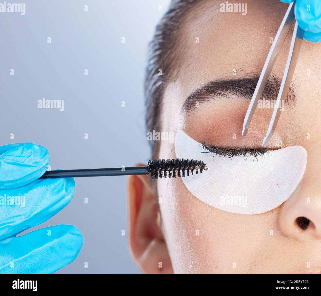 Woman, lashes and tweezer with mascara, studio closeup and makeup