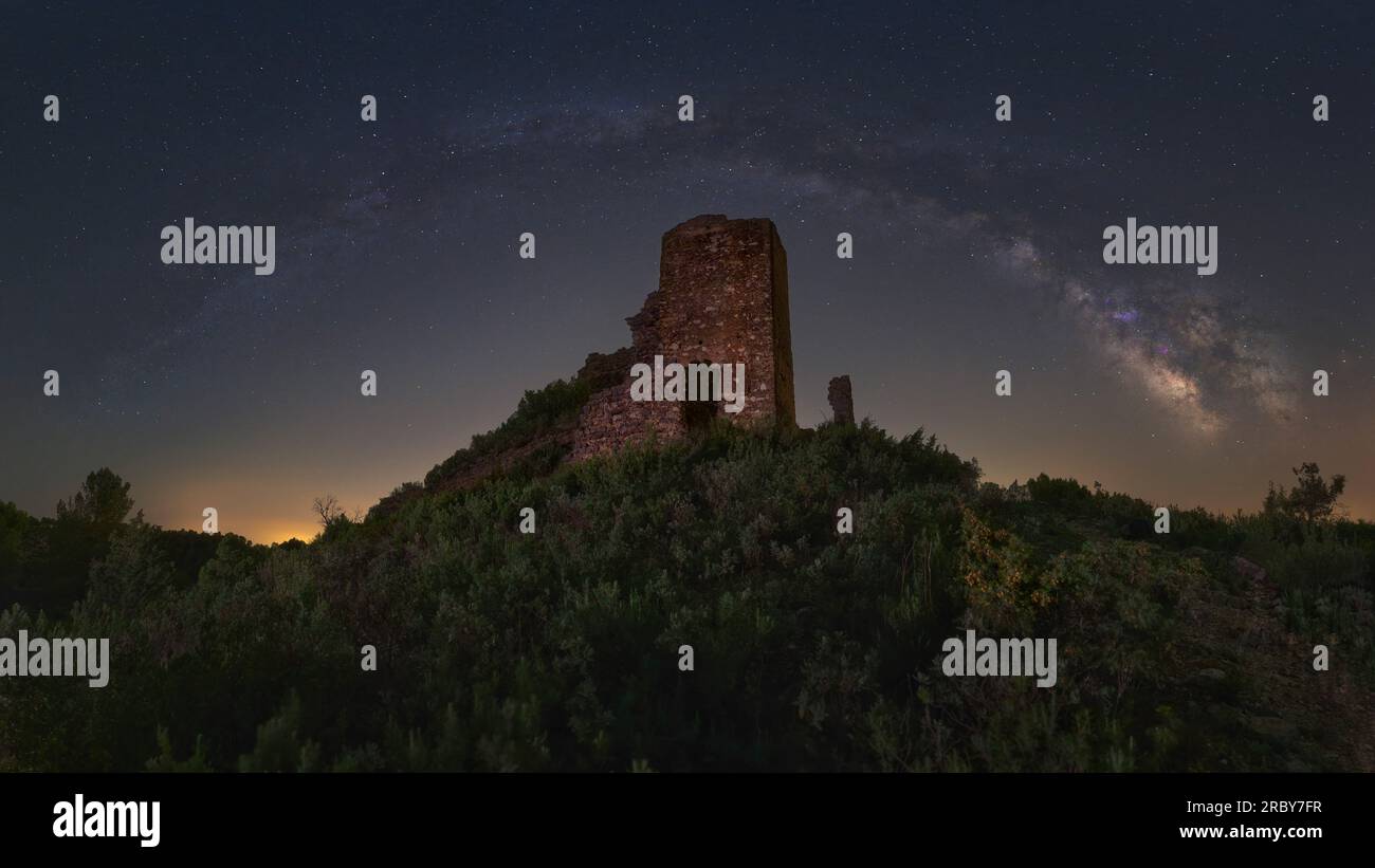 Panorama of the Milkyway arch over Chera's castle (Valencia - Spain) Stock Photo