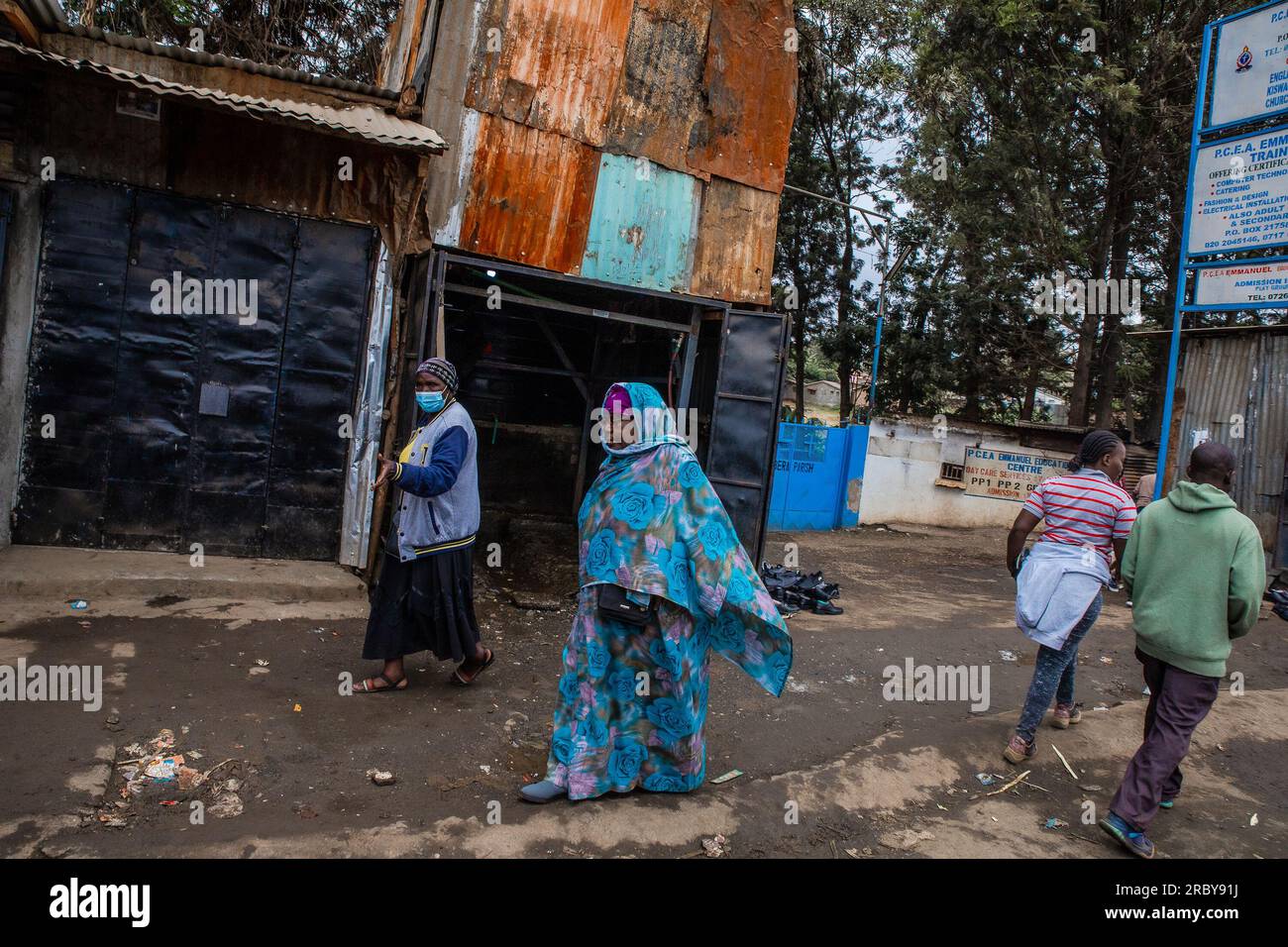 NAIROBI, KENYA-JULY 04, 2023: Residents walk past the streets in Kibera Slums. This series captures the day-to-day life through the streets of Nairobi Stock Photo