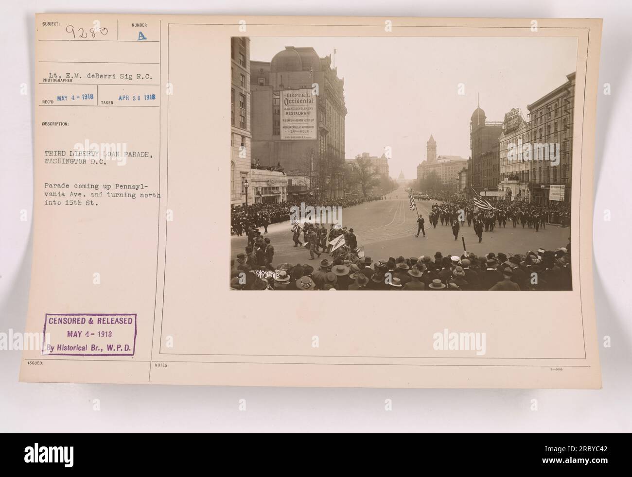 'Image captured on April 26, 1918, during the Third Liberty Loan Parade in Washington D.C. The photo shows the parade on Pennsylvania Ave, turning north into 15th St. Censored and released on May 4, 1918, by the Historical Branch of the War Plans Division. Notes mention the Hotel Occidental and restaurant.' Stock Photo
