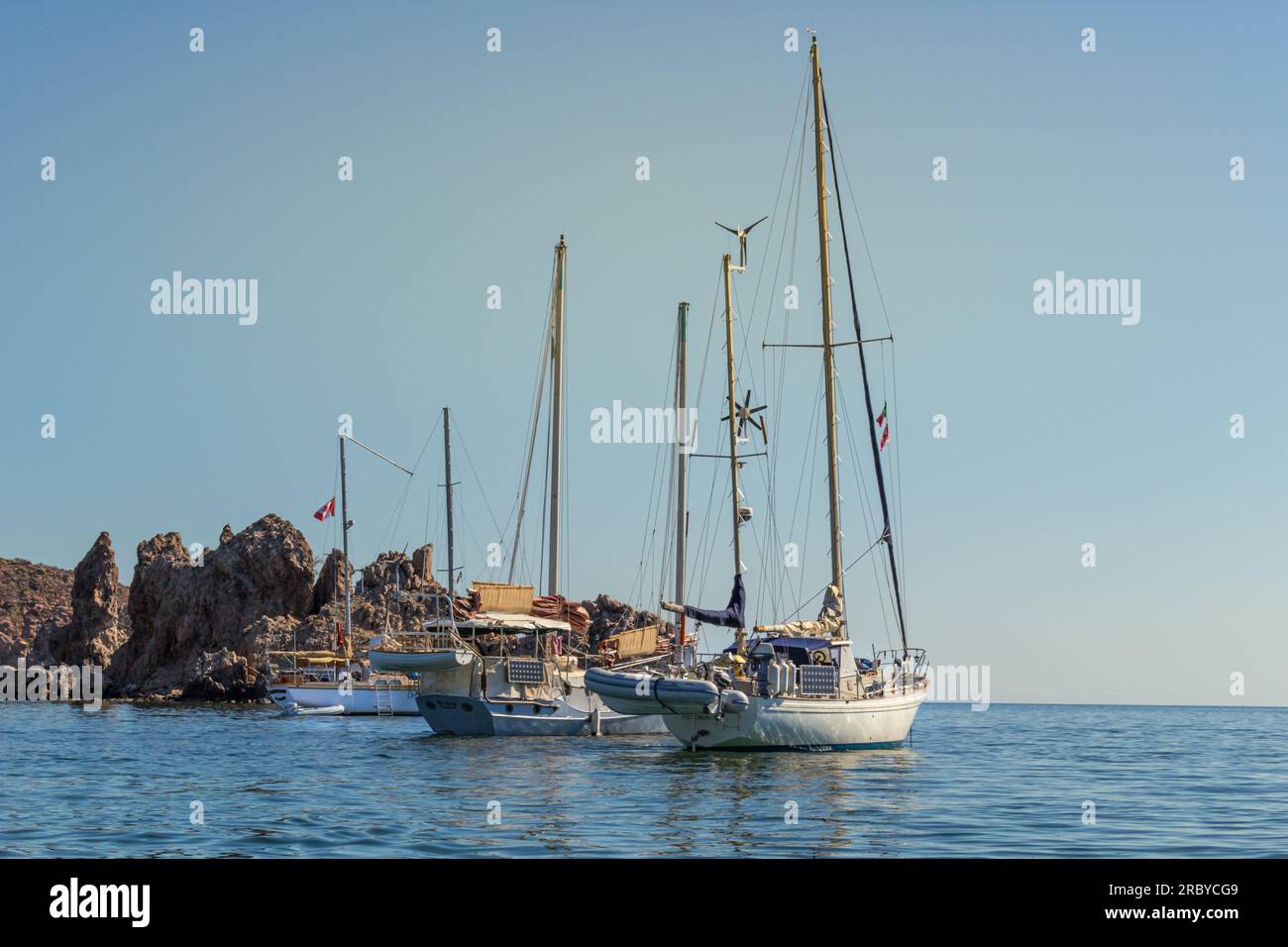 Three cruising sailboats, a schooner and two ketches, anchored in the calm bay aff San Juanico, Baja California Sur, Mexico. Stock Photo
