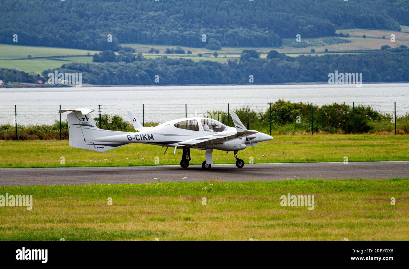 G-CIKM Diamond DA-42 Twin Star aircraft taking off from Dundee Riverside Airport, Scotland Stock Photo