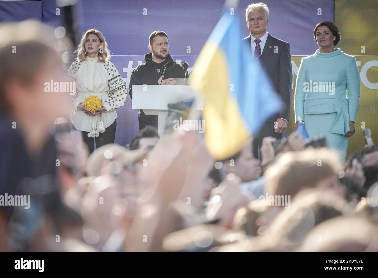 Vilnius, Lithuania. 11th July, 2023. Volodymyr Selenskyj, President of Ukraine, and his wife Olena Selenska sing the Ukrainian national anthem alongside Gitanas Naus·da (2nd vr), President of Lithuania, and his wife Diana Nausediene on the sidelines of the NATO summit after a public address in the Lithuanian capital. Among the topics to be discussed at the summit will be further steps to strengthen deterrence and defense. It will also discuss defense spending targets and continued support for Ukraine. Credit: Kay Nietfeld/dpa/Alamy Live News Stock Photo