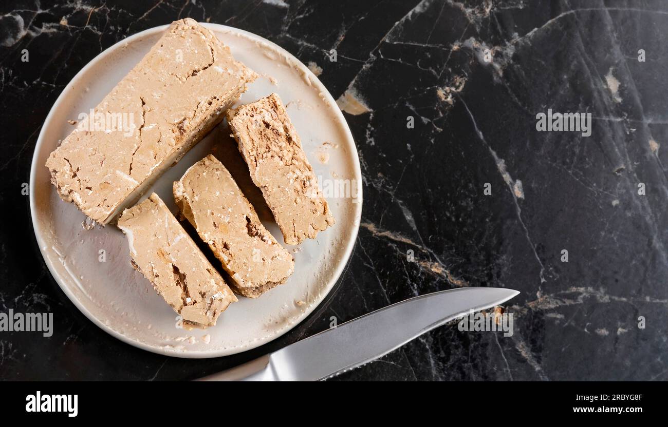 Two striped piece of halva with cocoa on a white background Stock Photo
