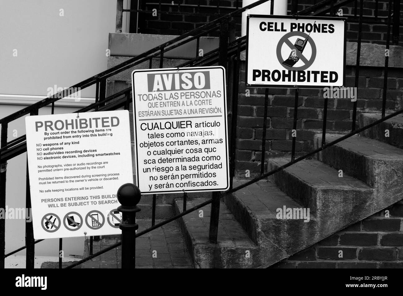 Signs in English and Spanish posted near a courthouse entrance in Abingdon, Virginia, USA. Stock Photo