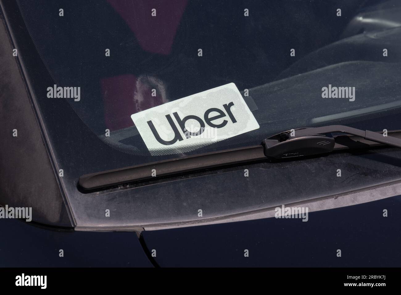 Muncie - July 10, 2023: Uber Car for hire sticker. Lyft and Uber have replaced many Taxi cabs for transportation with a smart phone app. Stock Photo