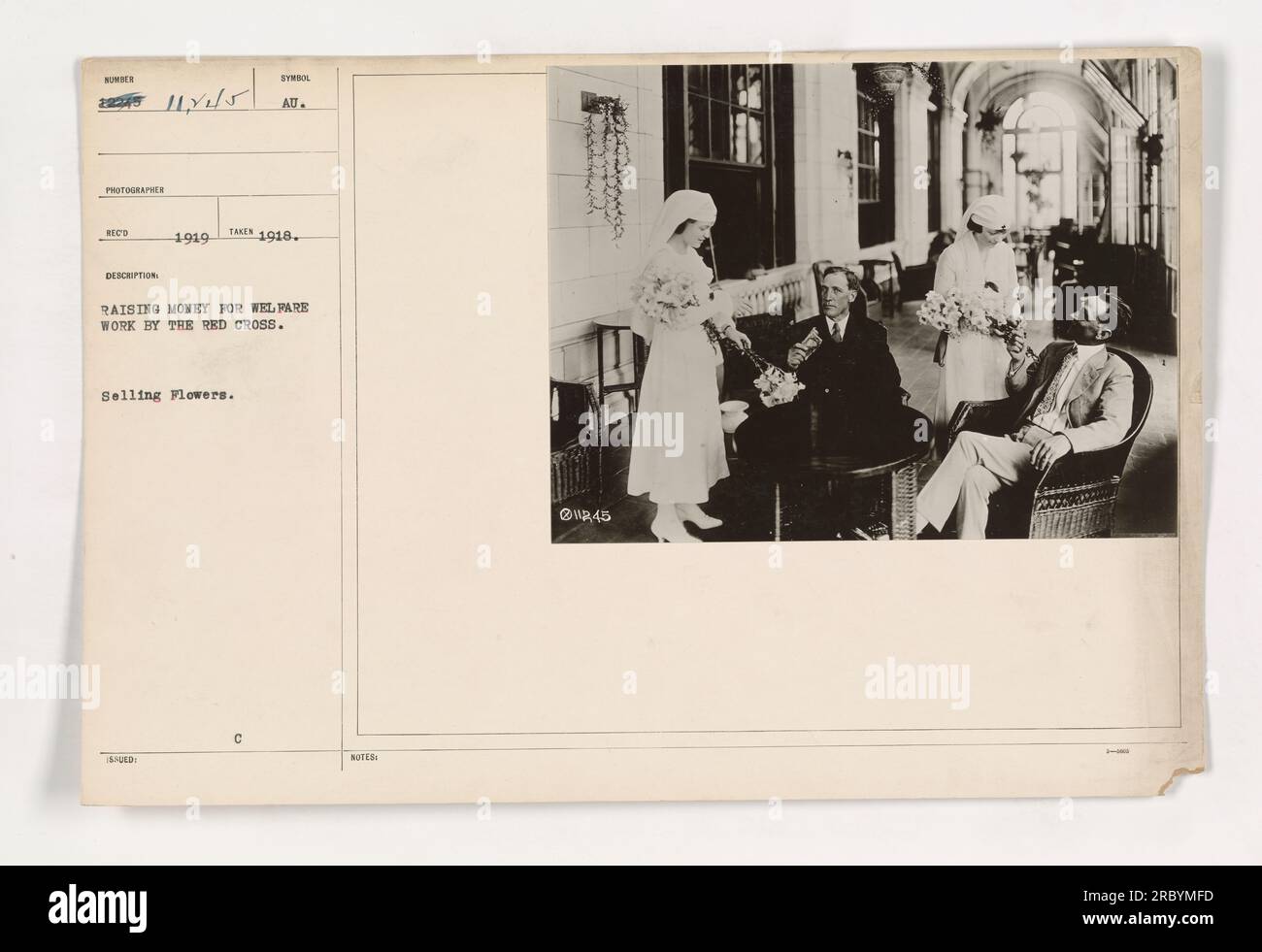 Soldiers at a military base in 1918 are seen wearing badges and selling