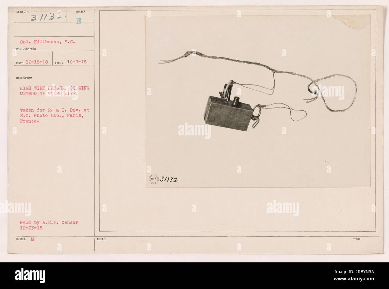 Soldier demonstrating the method of tying wire on a high wire hanger. The photo was taken on October 7, 1918, by Cpl. Hillhouse in Paris, France. It was taken for the R. & I. Division at the S.C. Photo Lab. The photograph is currently held by the A.E.F. Censor and was issued with the notes 31132. Stock Photo