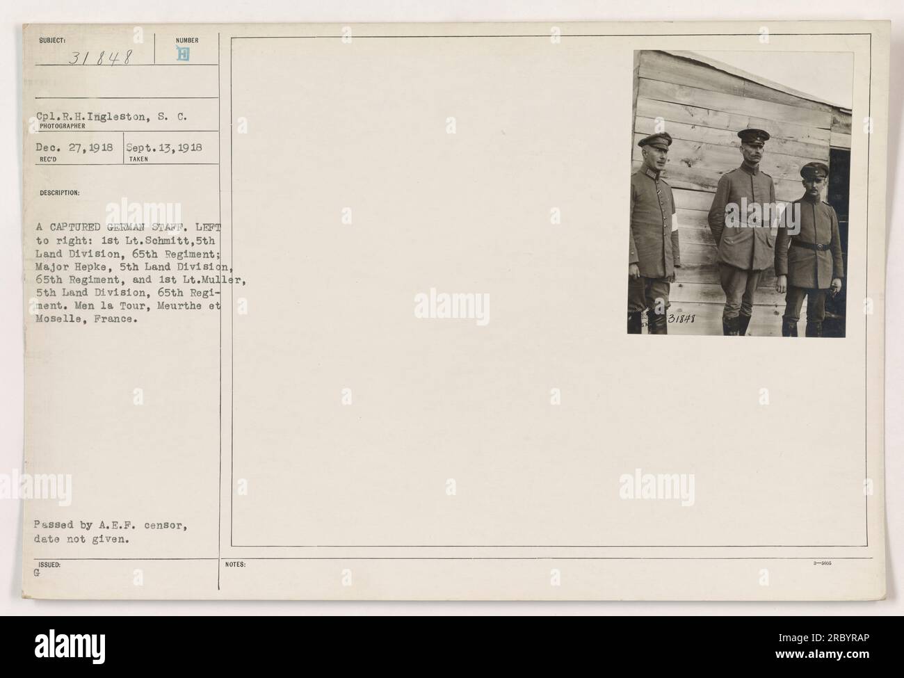 Cpl. R. H. Ingleston captured a photo of a group of captured German officers during WWI. The officers are identified as 1st Lt.Schmitt, Major Hepke, and 1st Lt.Muller of the 5th Land Division, 65th Regiment. The photo was taken in Men la Tour, Meurthe et Moselle, France. It has been approved and passed by the A.E.F censor. Stock Photo