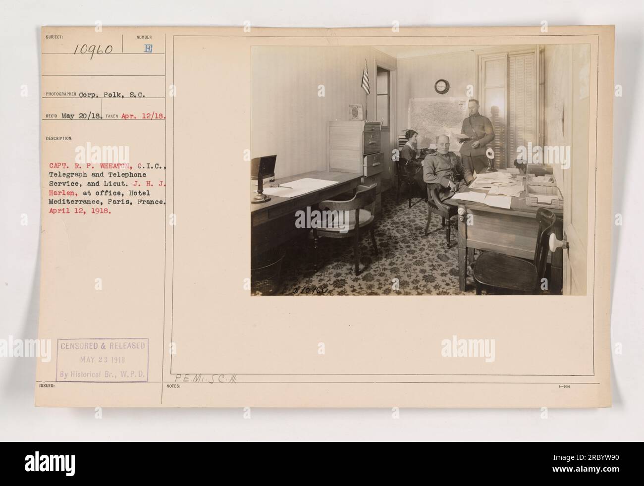 Captain R.P. Wheaton, O.I.C., and Lieutenant J.H.J. Harlen are seen in their office at Hotel Mediterranee in Paris, France. The photo was taken on April 12, 1918, by Corp. Polk and released by the Historical Branch on May 23, 1918. The caption identifies the officers and their role in the Telegraph and Telephone Service. Stock Photo