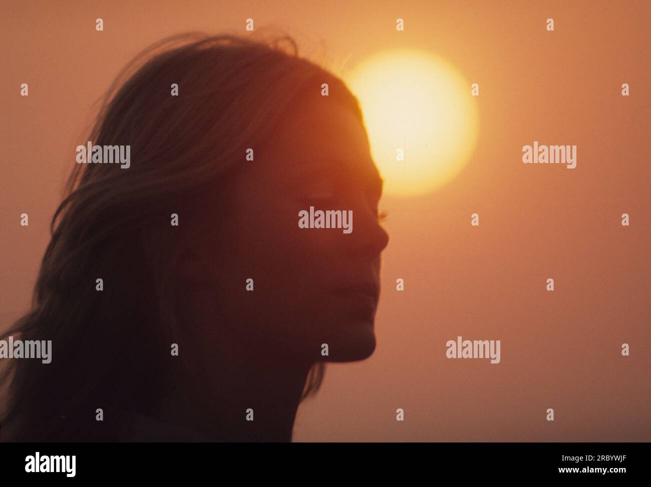 Profile portrait female face in front the sun hot ambiance dreaming Stock Photo