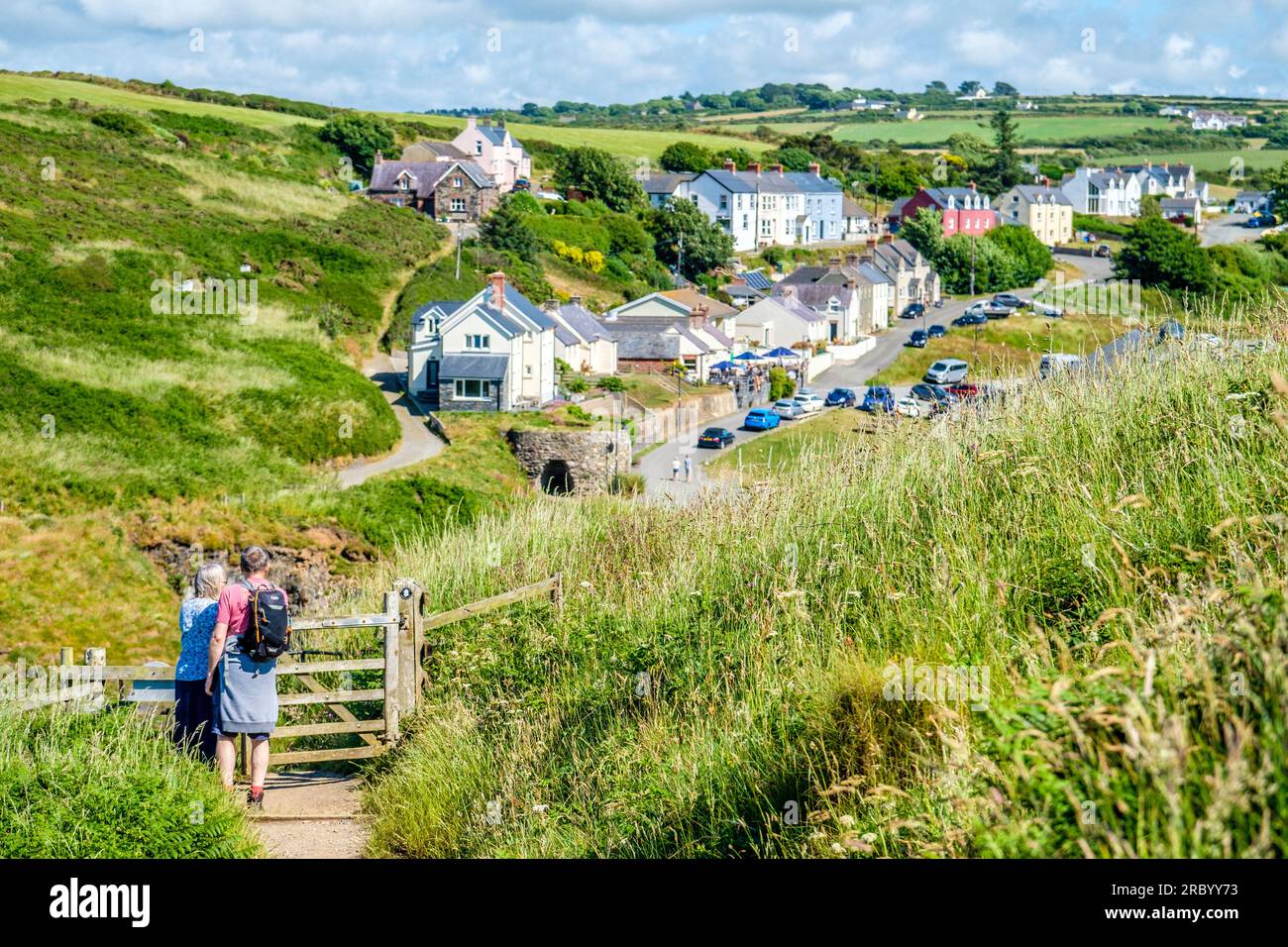 walkers on The Pembrokeshire Coast Path near Porthgain in west Wales, UK Stock Photo