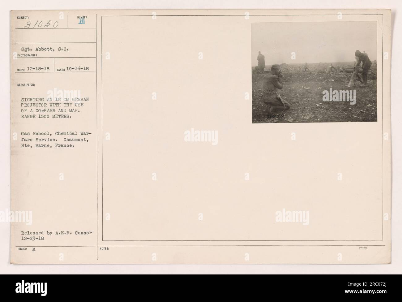 Sergeant Abbott, of the Chemical Warfare Service, is seen in this photograph sighting an 18 cm German projector using a compass and map. The range is estimated to be 1500 meters. This image was taken at the Gas School in Chaumont, Hte, Marne, France on October 14, 1918. It was released by A.E.P. Censor on December 23, 1918. Stock Photo